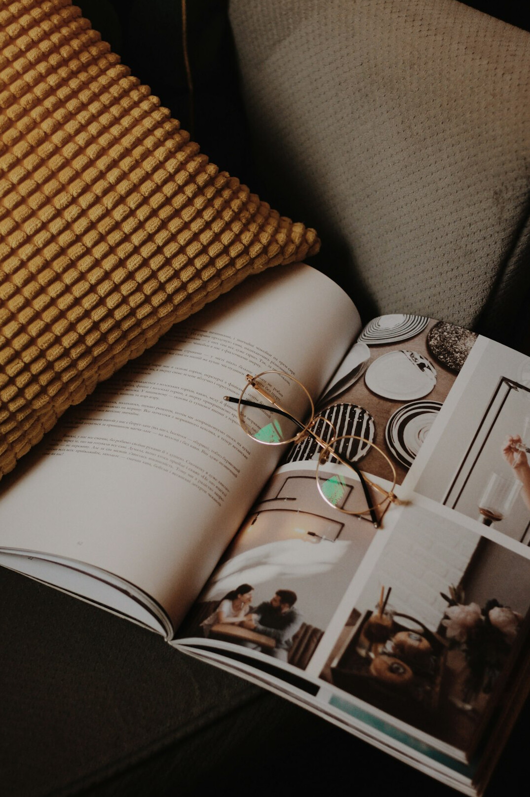Flat lay of glossy magazines with sunglasses and gold accessories
