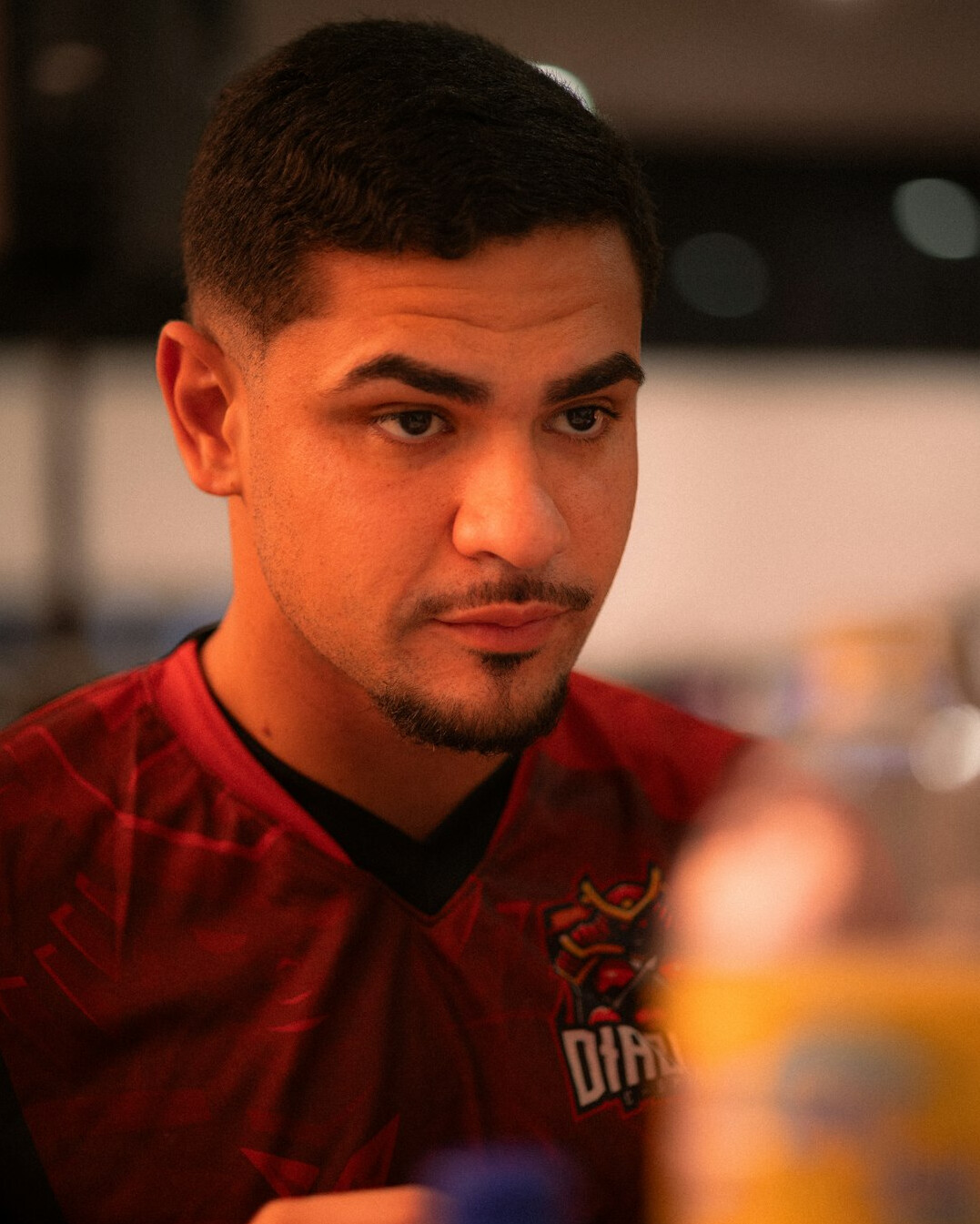 Young Latin man athlete in a red sports jersey portrait